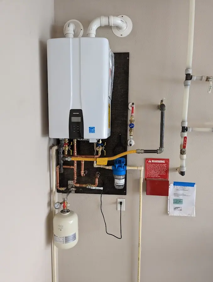 Professional plumber installing copper piping in a Hapeville home